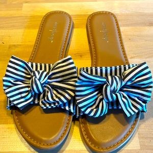 Super cute slippers/slides/flip flops. Fun black and white striped bow
